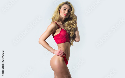 We need to live with passion. Fashion model with fit belly. Hair beauty of sensual girl. Perfect body shape. Sexy blond woman. Erotic lingerie and underwear. Sexy woman with long curly hair