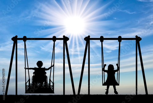 Canvas Print Happy child is handicapped in a wheelchair on an adaptive swing having fun with