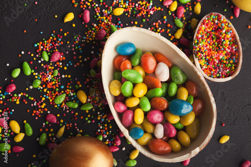 Chocolate egg and colorful candies photo