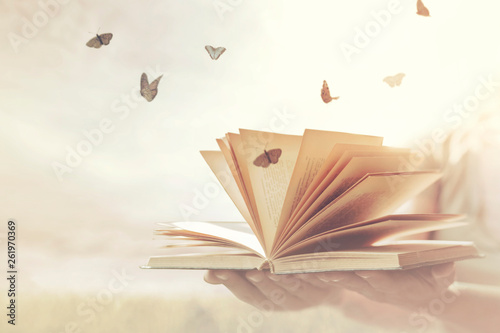 surreal moment of freedom for butterflies coming out of an open book photo