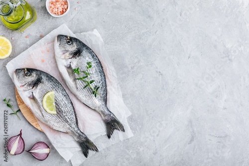 Fresh raw dorado fish with spices. Ingredients for cooking or grill on cutting board.