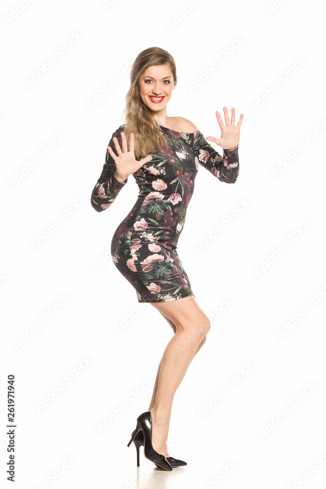 young blonde woman posing in tight dress on white background young blonde woman posing in tight dress on white background