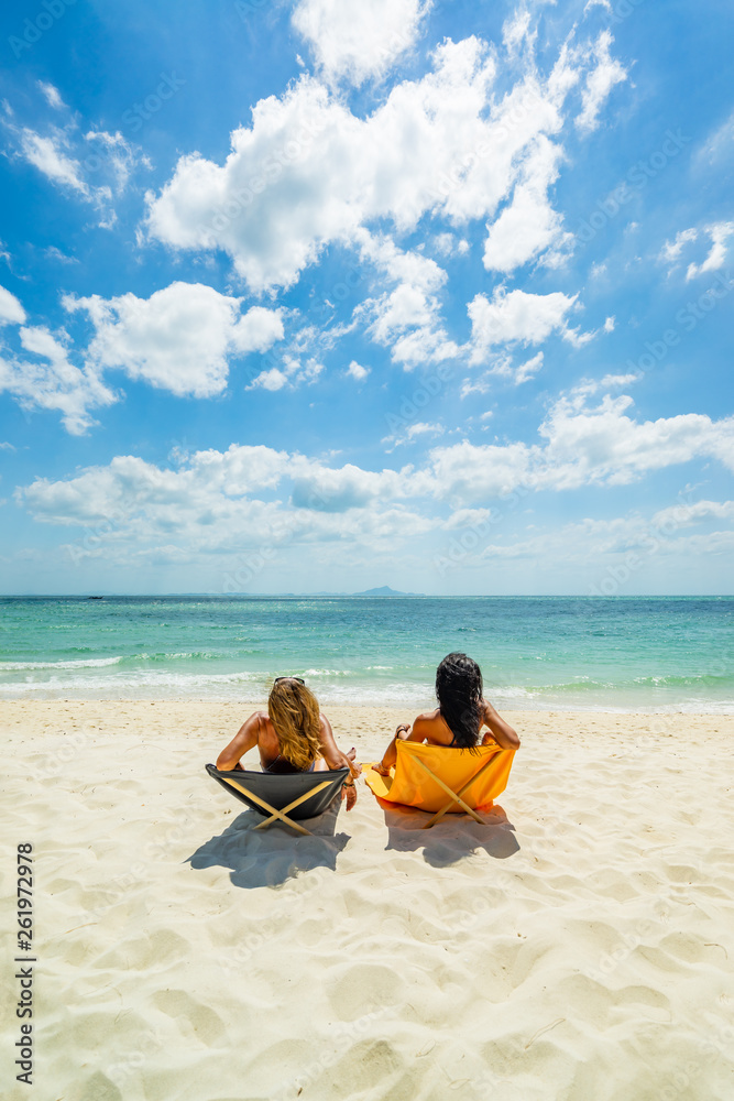 Woman enjoying her holidays on a transat at the tropical beach Woman enjoying her holidays on a transat at the tropical beach