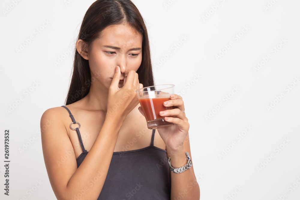 Young Asian woman hate tomato juice. Young Asian woman hate tomato juice.