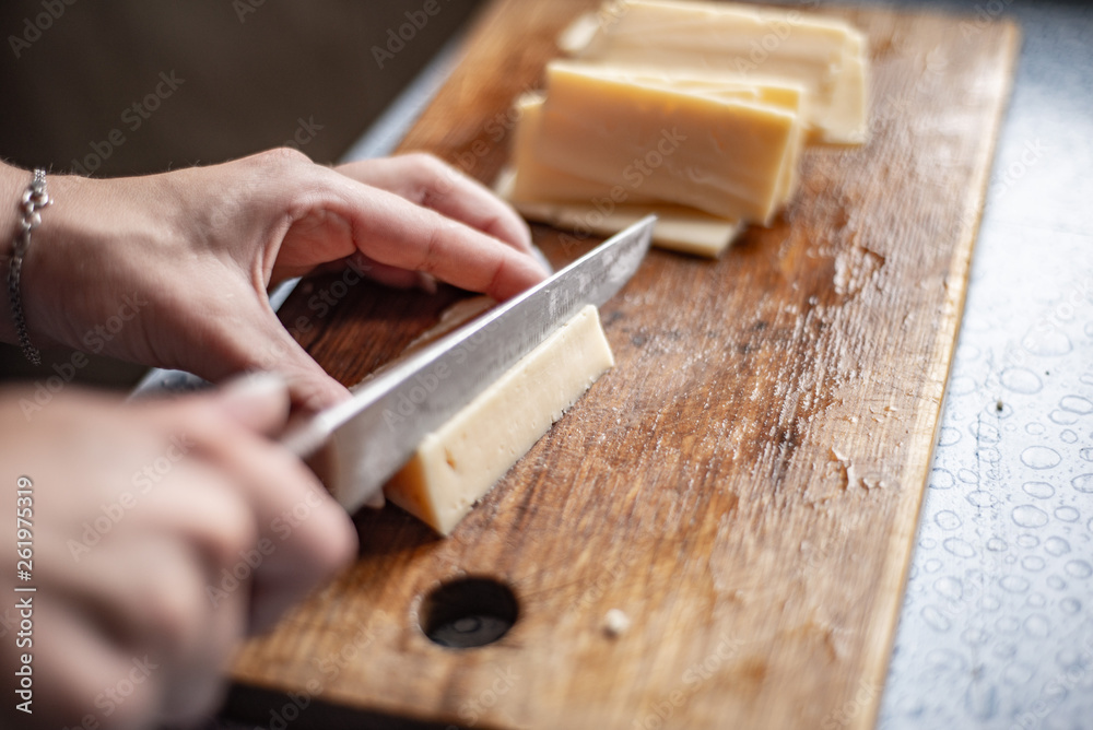 sliced cheese on a chopping wooden board sliced cheese on a chopping wooden board