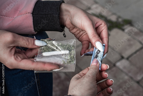 buying a sachet of drugs: a plastic bag of synthetic smoking substances and Marijuana Cannabis Joint