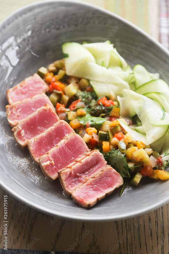 Tuna steak served with vegetables
