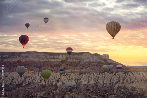 Hot Air balloons flying tour over Mountains landscape spring sunset Cappadocia, Goreme Open Air Museum National Park, Turkey nature background. photo