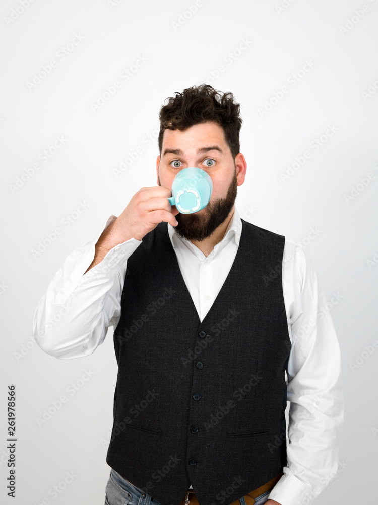 handsome, young man with black beard posing with turquoise coffee cup or tea cup in front of white background and making different facial expressions handsome, young man with black beard posing with turquoise coffee cup or tea cup in front of white background and making different facial expressions