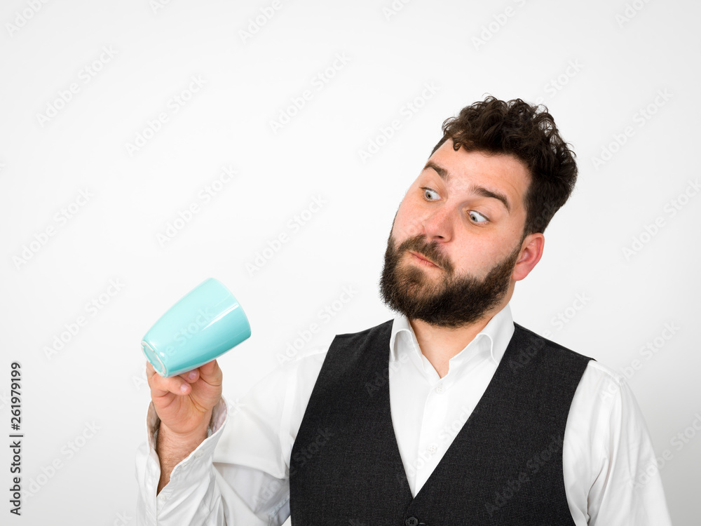 handsome, young man with black beard posing with turquoise coffee cup or tea cup in front of white background and making different facial expressions handsome, young man with black beard posing with turquoise coffee cup or tea cup in front of white background and making different facial expressions