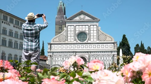 Male tourist taking picture of Santa Maria Novella church, Florence, Italy. Caucasian man with camera traveling to Tuscany, things to do, photo holidays in Europe, sightseeing of Italian tour