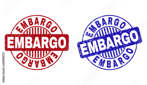 Grunge EMBARGO round stamp seals isolated on a white background. Round seals with grunge texture in red and blue colors. Vector rubber overlay of EMBARGO tag inside circle form with stripes.
