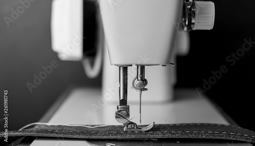 Background type of sewing machine, leather belt sewing process. Leather workshop. photo