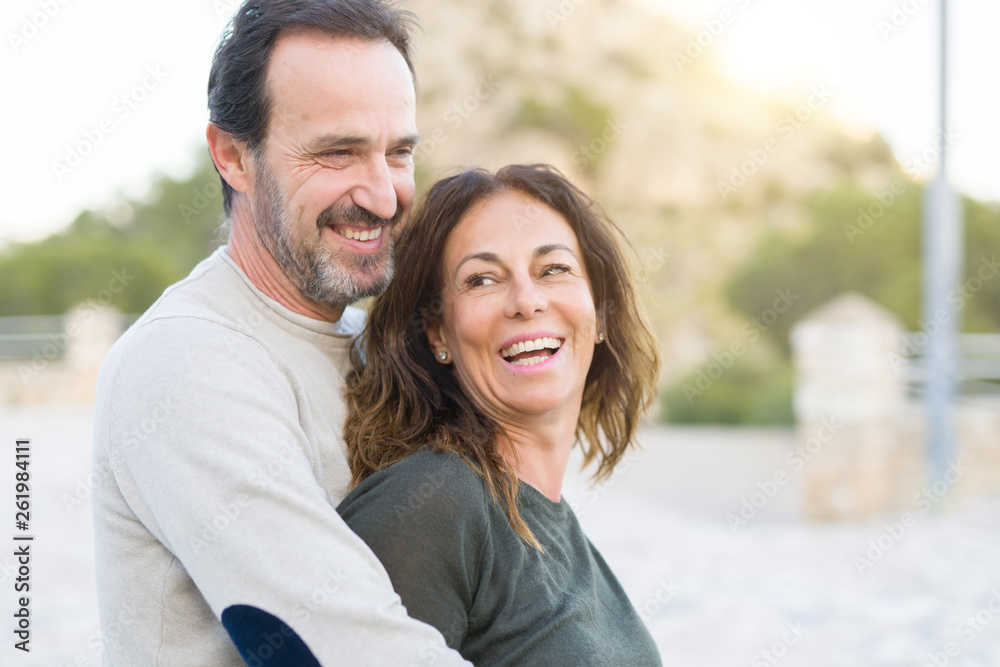 Romantic couple smiling, cuddling and hugging on a sunny day Romantic couple smiling, cuddling and hugging on a sunny day