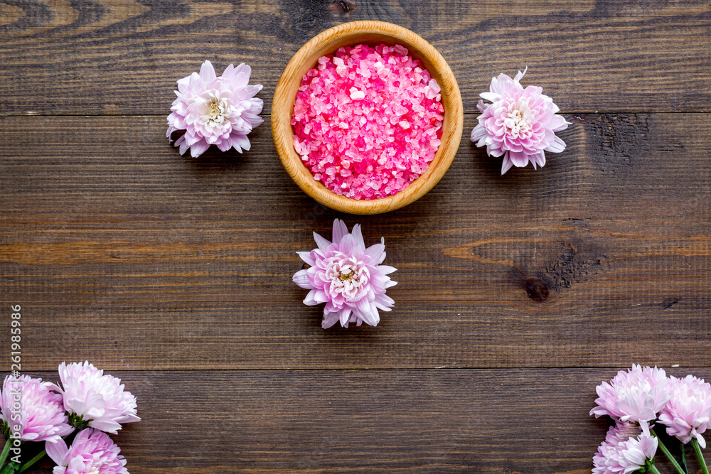 pink spa salt for aroma therapy with flower fragrance on wooden background top view pink spa salt for aroma therapy with flower fragrance on wooden background top view