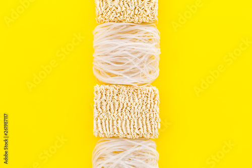 Chinese and Japanese food cooking with rice vermicelli, noodles on yellow background top view mockup photo