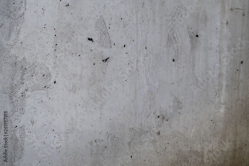 Concrete wall with stains, cracks and holes
