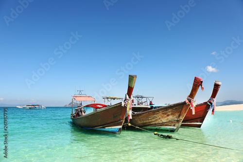 Longtale boat on the white beach at Phuket  Thailand. Phuket is a popular destination famous for its beaches.