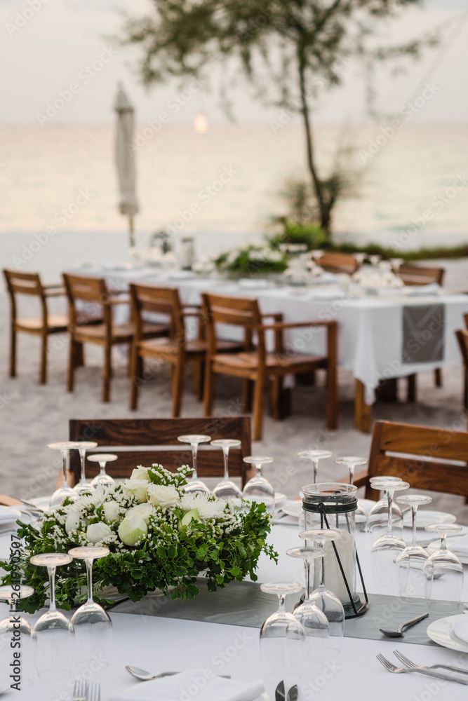 romantic wedding table design at sunset outside on asian beach
