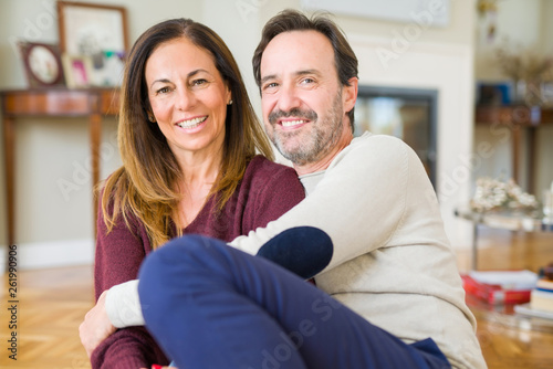 Beautiful romantic couple sitting together on the floor at home