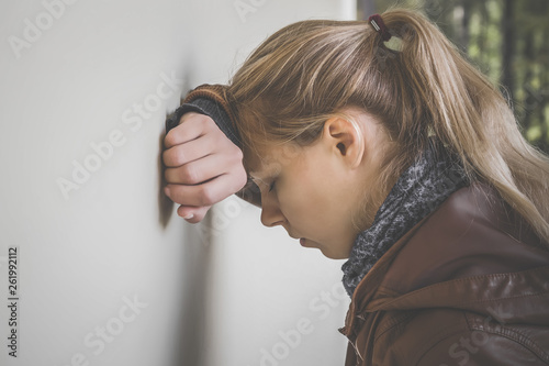 Obraz na plátně Young, adult, blonde lady relying on wall and trying to calm down