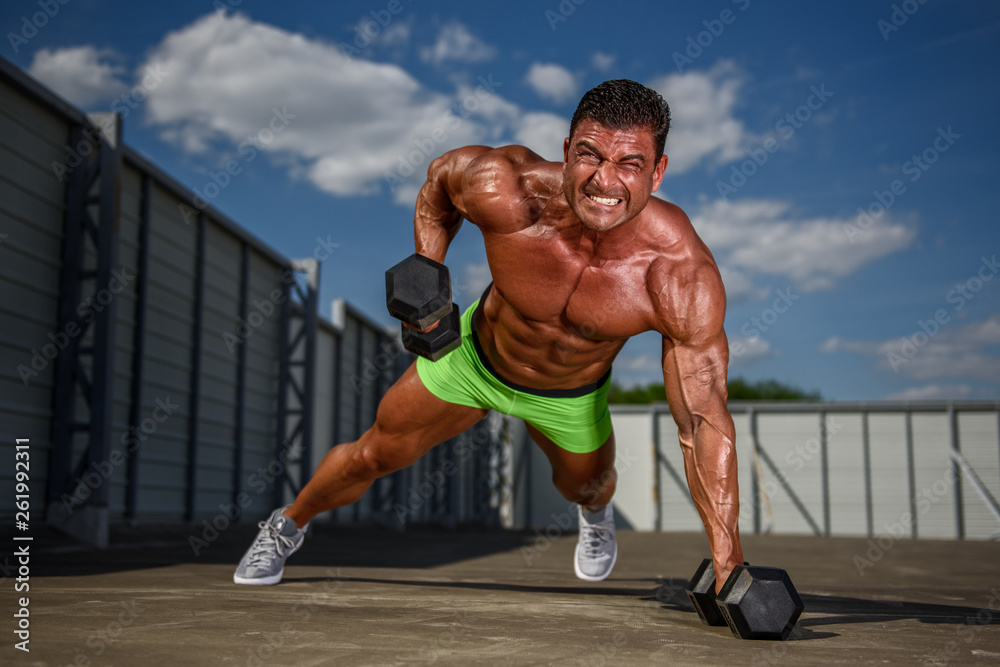 Bodybuilder exercise With Weights Outdoors Bodybuilder exercise With Weights Outdoors
