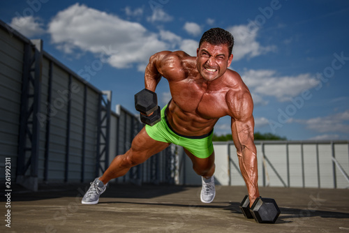 Bodybuilder exercise With Weights Outdoors