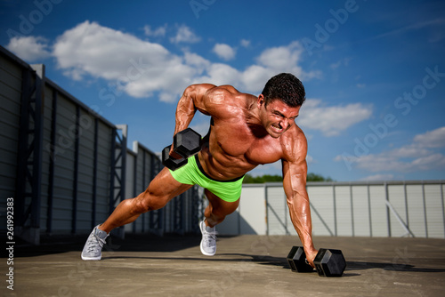 Bodybuilder exercise With Weights Outdoors