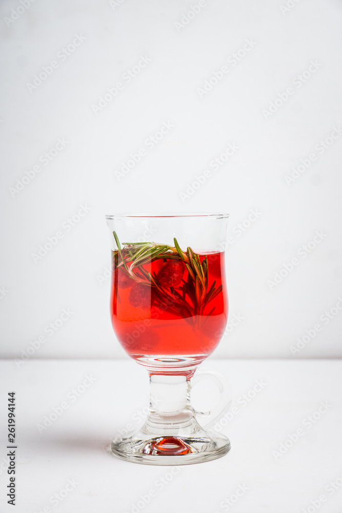 Hot raspberry beverage with rosemary. Selective focus. Shallow depth of field. Hot raspberry beverage with rosemary. Selective focus. Shallow depth of field.