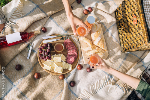 Girls drink multifruit juice in the park. Flat lay food and drink concept. photo