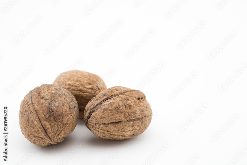 Walnuts on white background. The health benefits of walnuts are many. Walnuts on white background. The health benefits of walnuts are many.