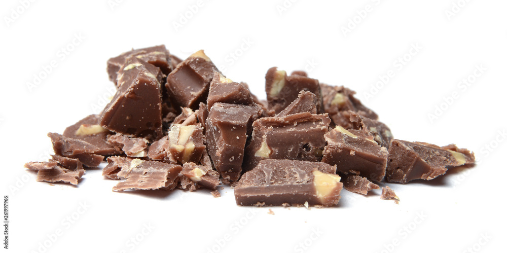 Slices of coarsely grated chocolate with nuts. White isolated background. Close-up. Side view. Slices of coarsely grated chocolate with nuts. White isolated background. Close-up. Side view.