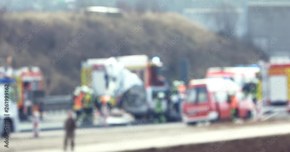 The blured view of paramedics and firemen providing first aid to victims in accident. The blured view of paramedics and firemen providing first aid to victims in accident.