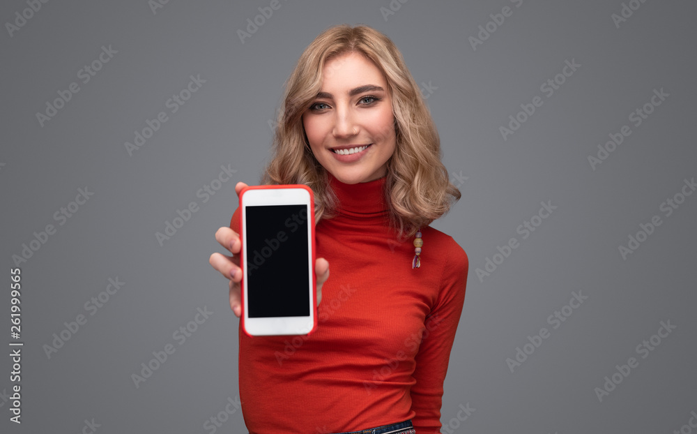 Smiling lady demonstrating smartphone Smiling lady demonstrating smartphone