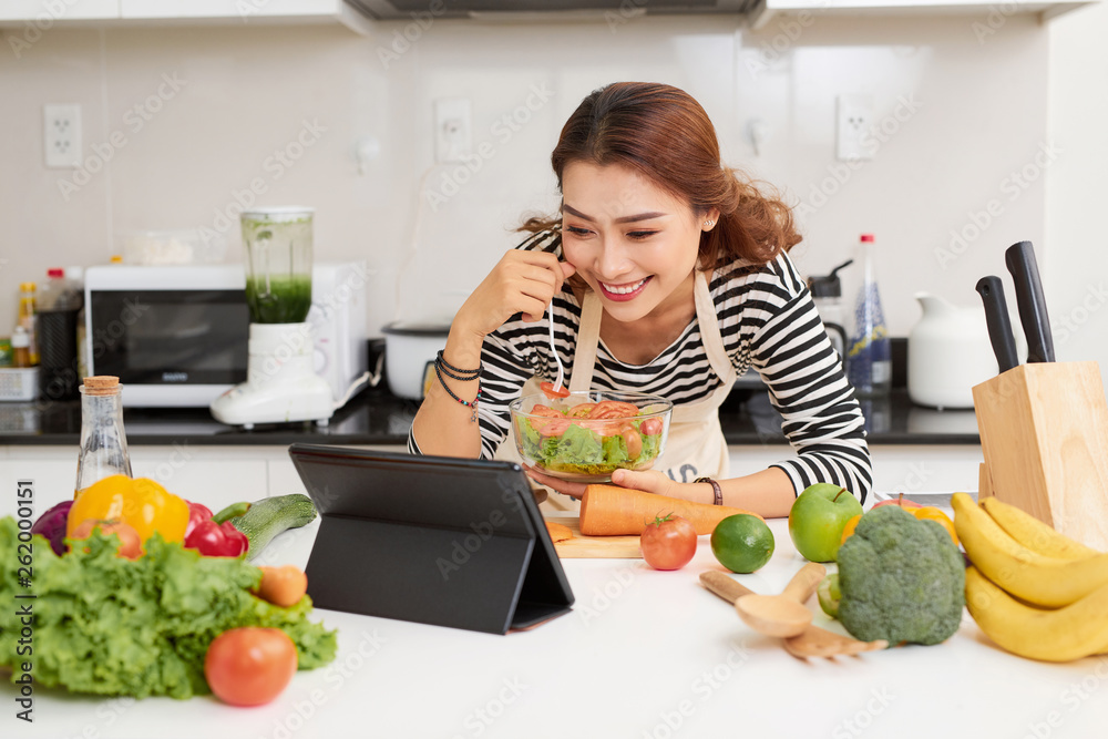 Healthy food at home. Happy woman is preparing the vegetables and fruit in the kitchen. Healthy food at home. Happy woman is preparing the vegetables and fruit in the kitchen.