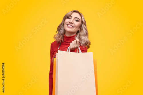 Smiling woman with bunch of paper bags