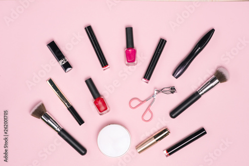 Make up or visage background. Female bag and different make up accessories, brushes, lipstick, and pencils.