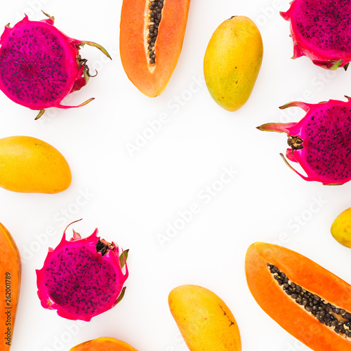 Fototapeta Naklejka Na Ścianę i Meble -  Food frame of papaya, mango and dragon fruits on white background. Flat lay