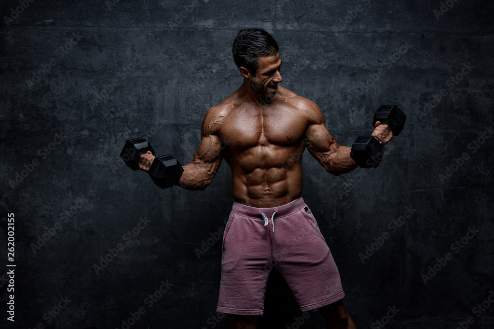 Muscular Men Lifting Weights. Performing Dumbbel Biceps Curls