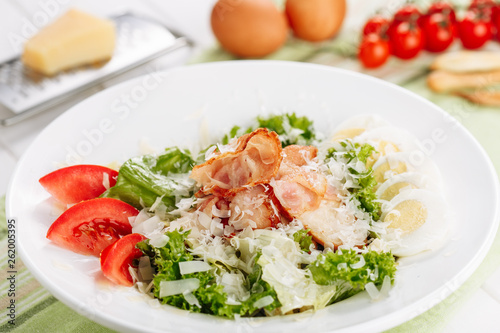 Roast Ham in Fresh Salad with Egg and Tomato Slice Side View. Delicious Prosciutto and Vegetable Plate Appetizer for Dinner. Healthy Cuisine Diet Traditional Breakfast