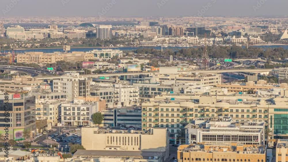 Aerial view of neighbourhood Deira and Dubai creek with typical old and modern buildings timelapse. Airport on a background. View from skyscraper rooftop. Dubai, United Arab Emirates Aerial view of neighbourhood Deira and Dubai creek with typical old and modern buildings timelapse. Airport on a background. View from skyscraper rooftop. Dubai, United Arab Emirates
