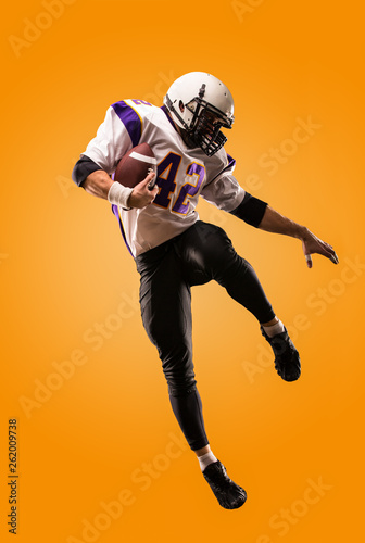 american football player in action. High jump of American football player photo
