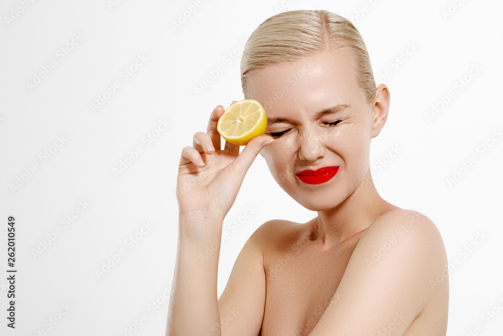 Beauty and Fashion. Beautiful blonde woman having a slice of lemon Beauty and Fashion. Beautiful blonde woman having a slice of lemon