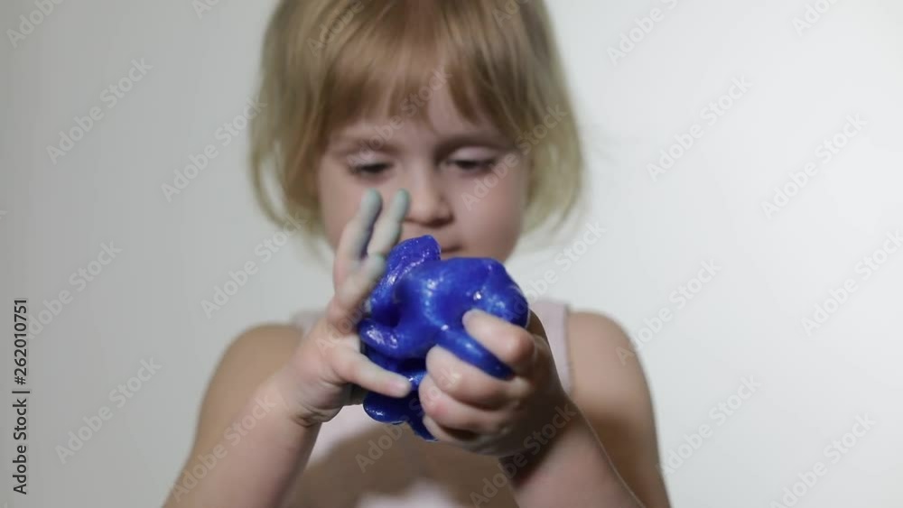 Child having fun making slime. Kid playing with hand made toy slime. Child having fun making slime. Kid playing with hand made toy slime.