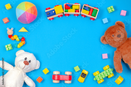 Baby kids toys background. Two teddy bears, wooden train, toy cars, colorful ...
