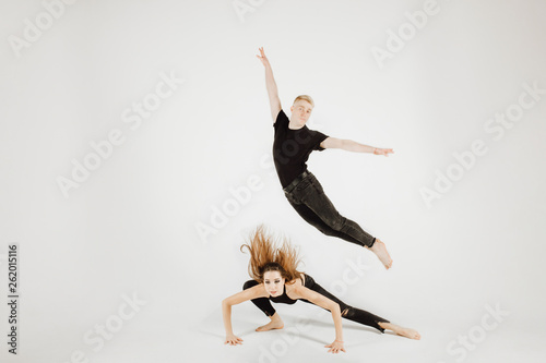 Dancer Woman and Man in Dynamic Action Figure Pose. Beautiful Modern Jazz Dance Couple in Black Picture in Motion Isolated on White Background. Muscular Male Perfomer do Soubresaut Jump