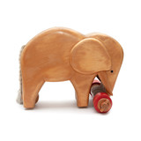 Wooden elephant with red wheels and tail from side