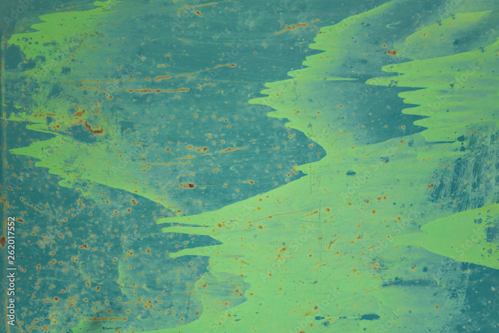 old blue metal wall shield with stains of green paint, scratches and dots of brown rust. rough surface texture
