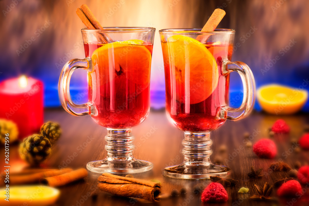 Glass cups of delicious hot mulled wine on wooden board Glass cups of delicious hot mulled wine on wooden board