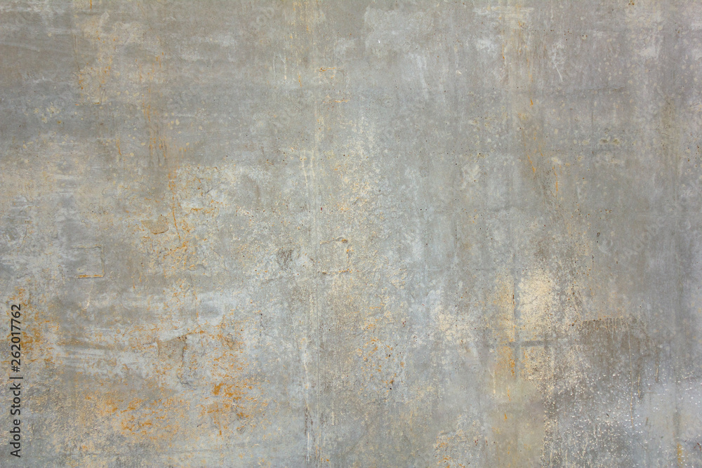 old dirty concrete wall with white and yellow spots of paint and scratches. rough surface texture